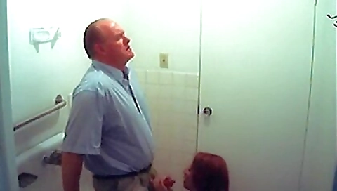 Hot brunette babe in a black dress is licking her cock