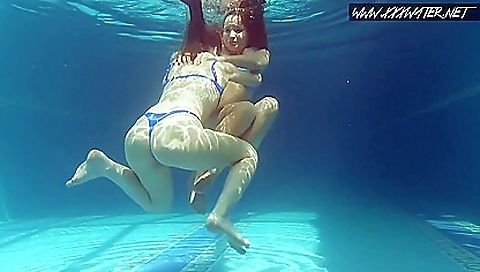 Lesbian redhead and blonde babes on top of a dildo