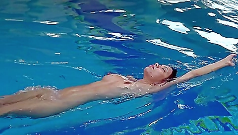 Skinny brunette in swimsuit enjoys the ocean under water