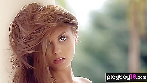 Bright redhead woman in a sexy outfit in her bedroom