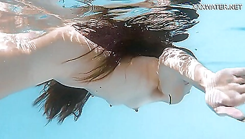 Brunette naked on the beach with sexy towel and towel