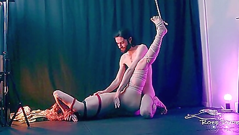 Sexy petite brunette in a pink dress gives a blow job to her manhood